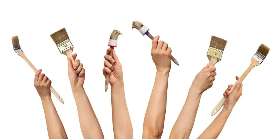 Set of paint brushes in hands Stock Photos