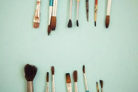 Set of paint brushes on the light blue background Stock Photos