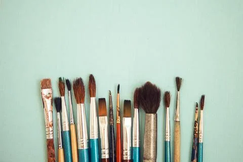 Set of paint brushes on the light blue background Stock Photos