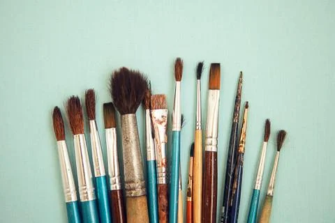 Set of paint brushes on the light blue background Stock Photos