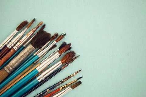 Set of paint brushes on the light blue background Stock Photos