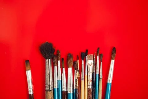 Set of paint brushes on the red background Stock Photos