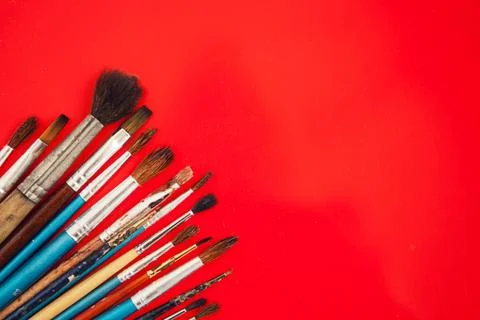 Set of paint brushes on the red background Stock Photos
