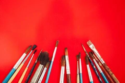 Set of paint brushes on the red background Stock Photos