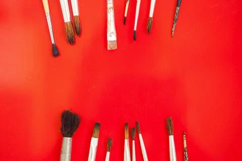 Set of paint brushes on the red background Stock Photos