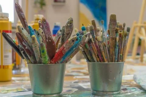Set of paintbrushes multi-colored on the cup. Paint brushes and paints for dr Stock Photos