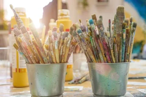 Set of paintbrushes multi-colored on the cup. Paint brushes and paints for dr Stock Photos