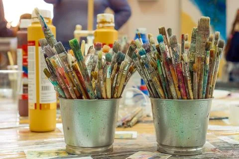 Set of paintbrushes multi-colored on the cup. Paint brushes and paints for dr Fotos Stock