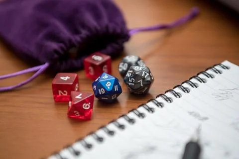 Set of pen, notebook, and dices to play role game like dungeons and dragons. Stock Photos