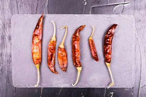 Set peppers on a dark background. Stock Photos