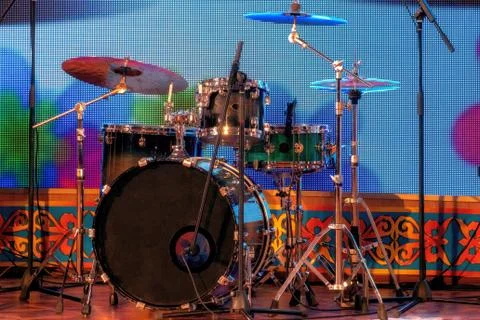 A set of percussion instruments on stage. Drums and plates. Racks and microph Stock Photos