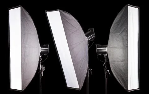 Set of photography studio flash with softbox isolated on black background. Stock Photos