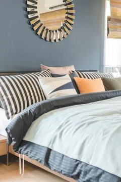 Set of pillows on bed with blanket Stock Photos
