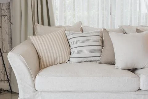 Set of pillows on classic sofa in modern living room Stock Photos