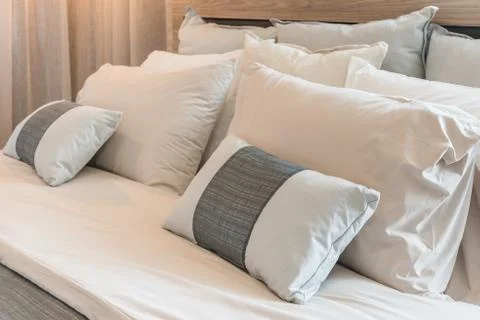 Set of pillows on modern bed Stock Photos
