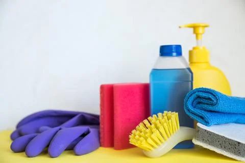 Set of plastic bottles of different cleaning procucts, rubber gloves and sponges Stock Photos
