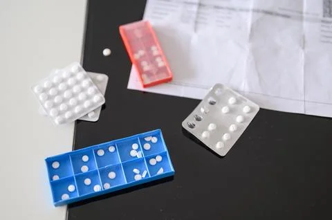 Set of plastic box with pills on table Stock Photos