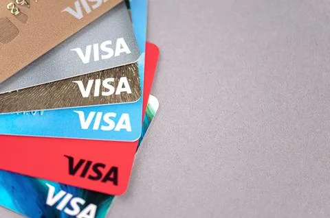 Set of plastic cards with Visa logotype on a desk with space for text Stock Photos