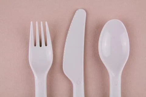 Set of plastic dishes spoon fork gray knife on the table reusable eco-friendl Stock Photos