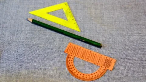 Set of plastic rulers and a protractor between the pencil Stock Photos