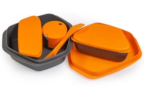 Set of plastic tourist dinnerware with closed containers and cup Stock Photos