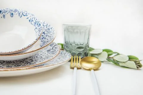 A set of plates of different sizes with a white middle and blue patterns on the Stock Photos