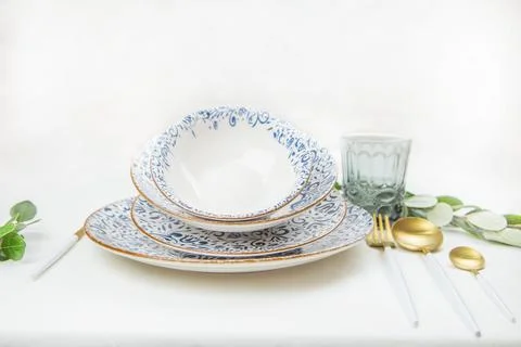 A set of plates of different sizes with a white middle and blue patterns on the Stock Photos