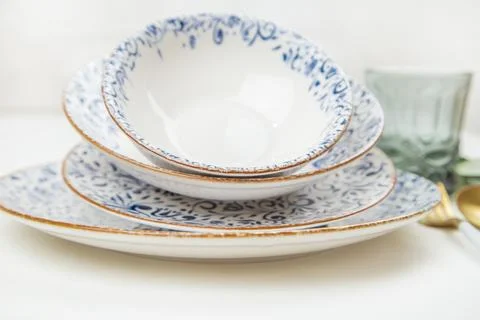 A set of plates of different sizes with a white middle and blue patterns on the Stock Photos