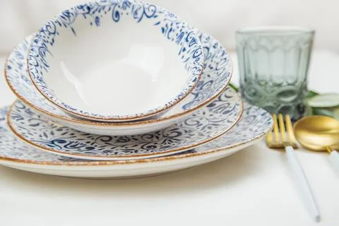 A set of plates of different sizes with a white middle and blue patterns on the Stock Photos