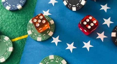 A set of poker chips stack on a green game table with a dice rolls. Black b.. Stock Photos