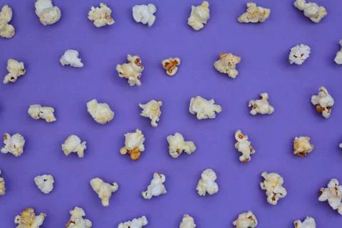 Set of popcorn on purple background Stock Photos