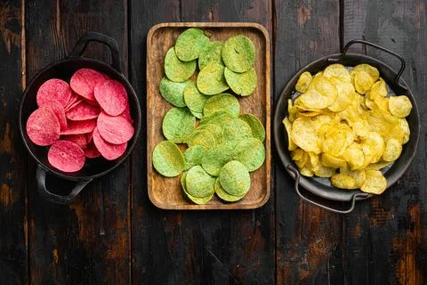 Set potato chips on old dark wooden table background, top view flat lay Stock Photos