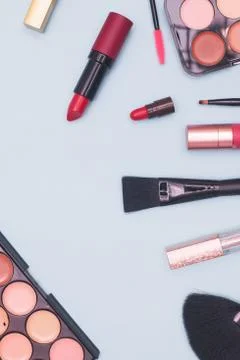 Set of professional cosmetics, makeup tools and accessories on blue background Stock Photos