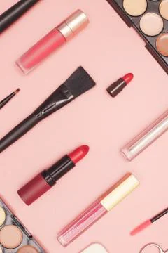 Set of professional cosmetics, makeup tools and accessories on pink background Stock Photos