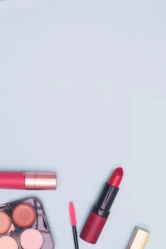 Set of professional cosmetics, makeup tools and accessories on blue background Stock Photos