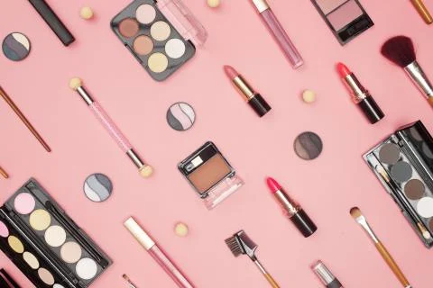 Set of professional cosmetics, makeup tools and accessories on pink background Stock Photos