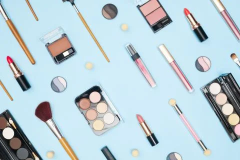 Set of professional cosmetics, makeup tools and accessories on blue background Stock Photos