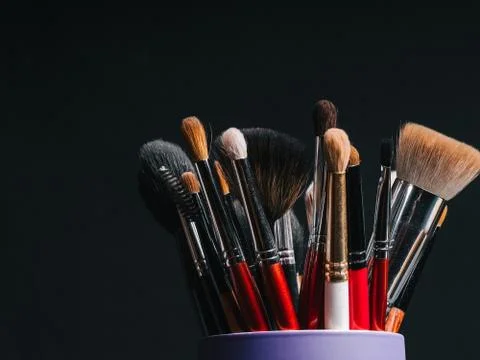 Set of professional makeup brushes on dark background Stock Photos