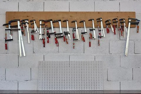 Set of professional tools hanging on white background Stock Photos