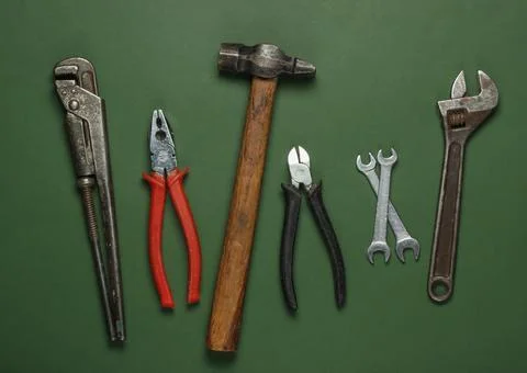 Set of professional work tools on green background. Top view. Stock Photos