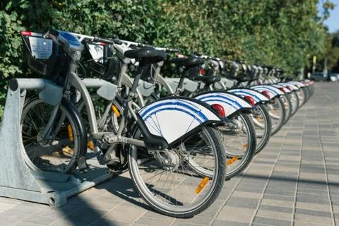 Set of public bikes on footpath Stock Photos