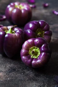 Set of purple peppers on table Stock Photos