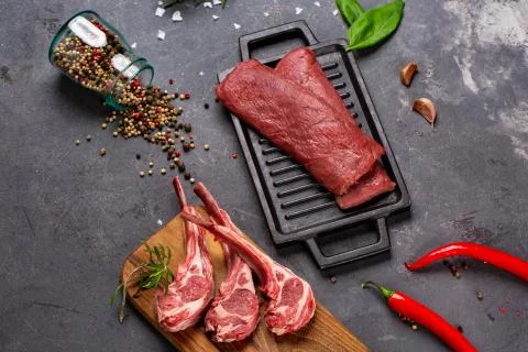 Set of Raw uncooked black angus beef tomahawk steaks on bones and veal tender Stock Photos