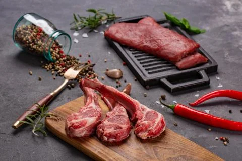 Set of Raw uncooked black angus beef tomahawk steaks on bones and veal tender Stock Photos