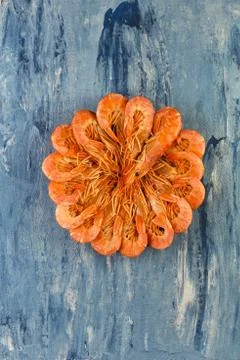 Set of red Argentine prawns in round on a blue background. Stock Photos