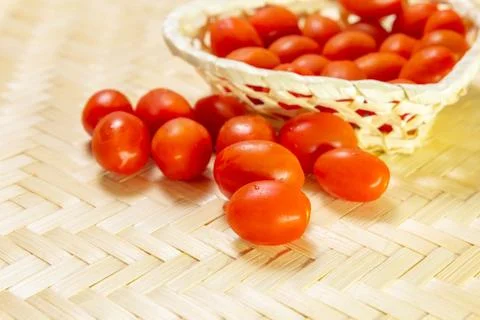 Set red cherry tomato wicker basket on wooden background vegetable design Stock Photos