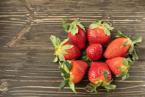 Set of red fresh strawberries on rustic wood table Stock Photos