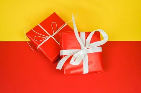 Set of red gift boxes on yellow-red surface with copy space. Stock Photos