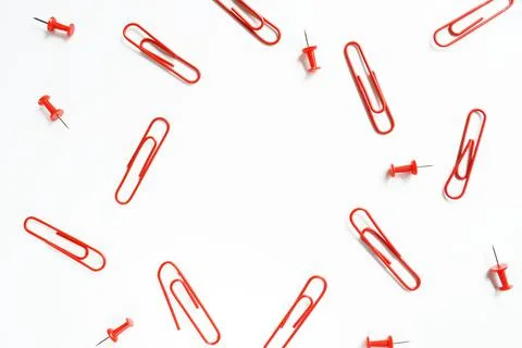 A set of red paper clips close-up on a white background. Stationery. Stock Photos