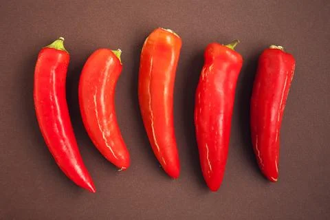 Set of red pepper on the brown background Stock Photos
